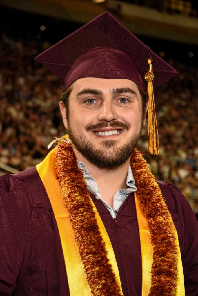 Bo Hubbard at ASU graduation in maroon and gold regalia